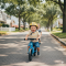 parent assisting baby boy with balance bikes
